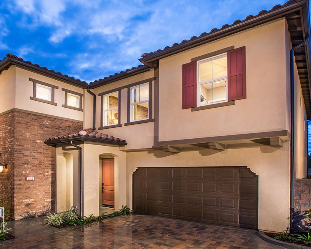 Southwest style single-family home with brick driveway